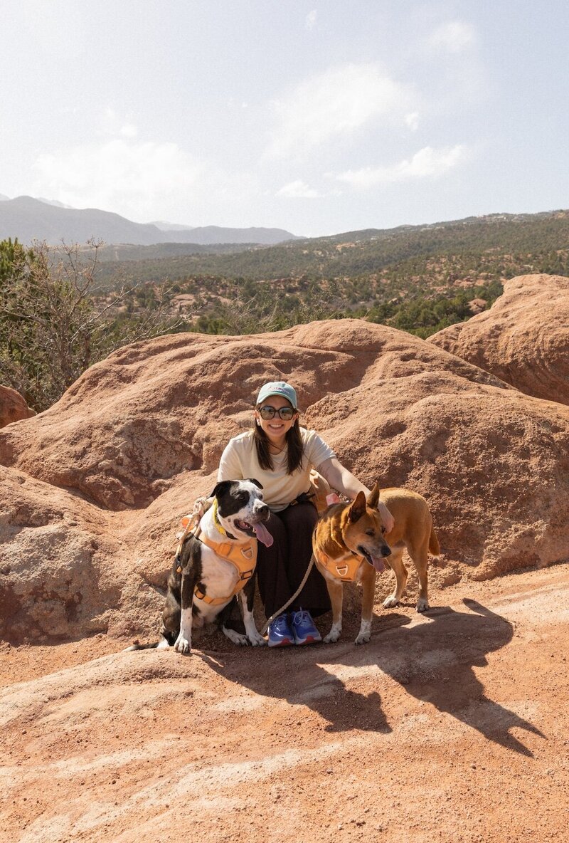 Portrait of Logan Ferree, Colorado wedding photographer, with her dogs at Garden of the gods