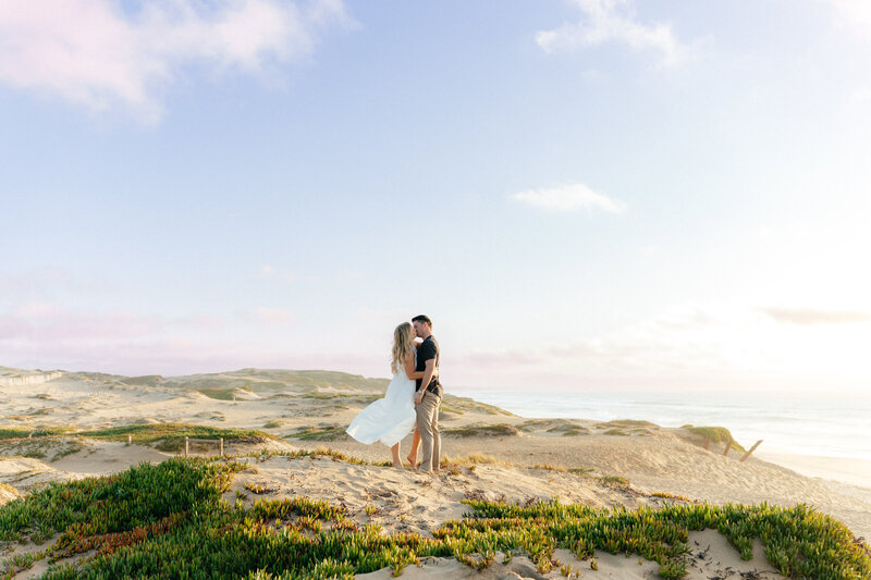 Wedding and Elopement Photographer, woman fanning herself in robe standing in a doorway
