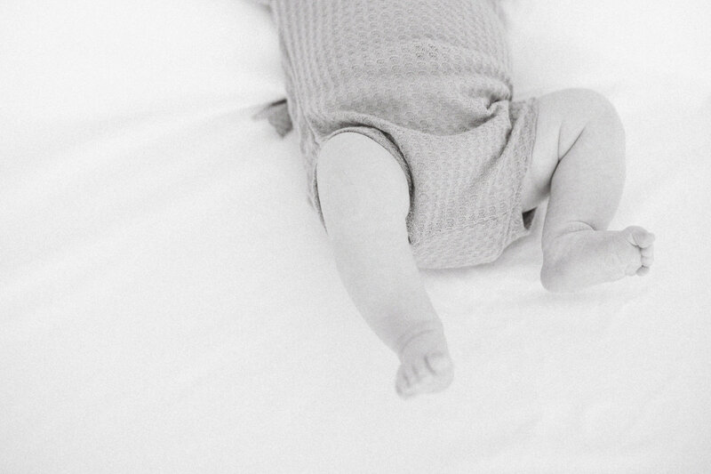 black and white of baby legs and feet