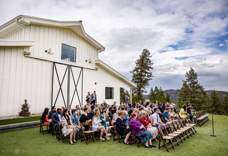 Wedding Ceremony on the Lawn Outside of The Woodlands Barn in Colorado