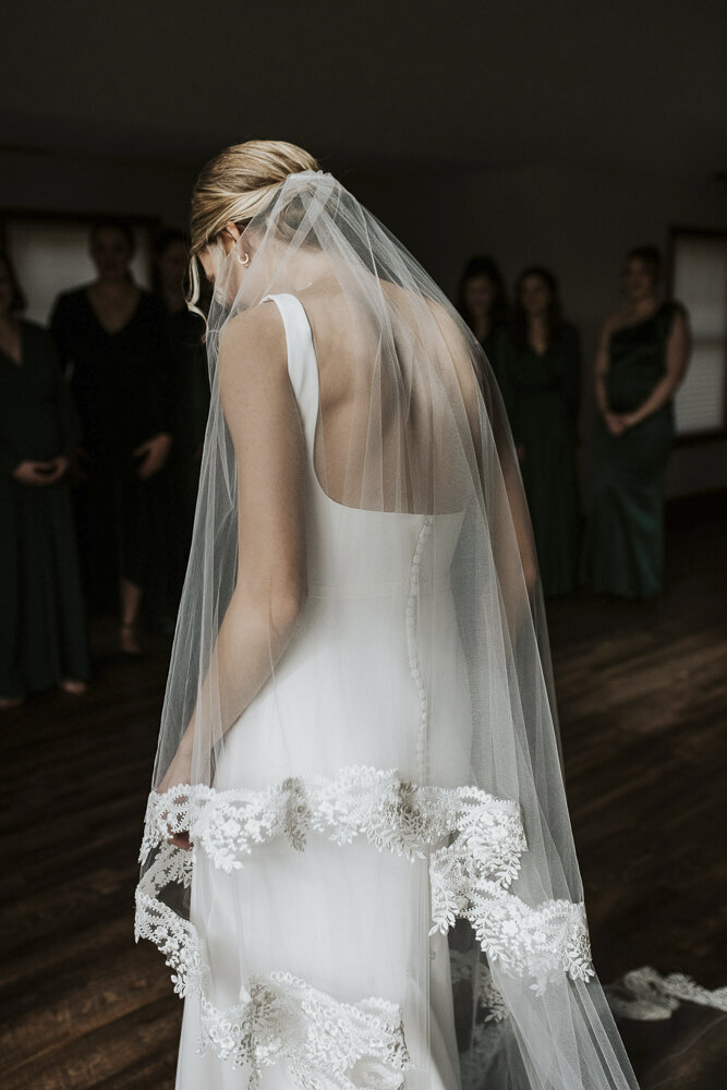 a bride in her wedding dress and veil
