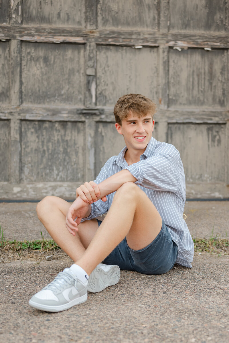 High school senior boy dressed casually, posing outdoors in Ann Arbor. 