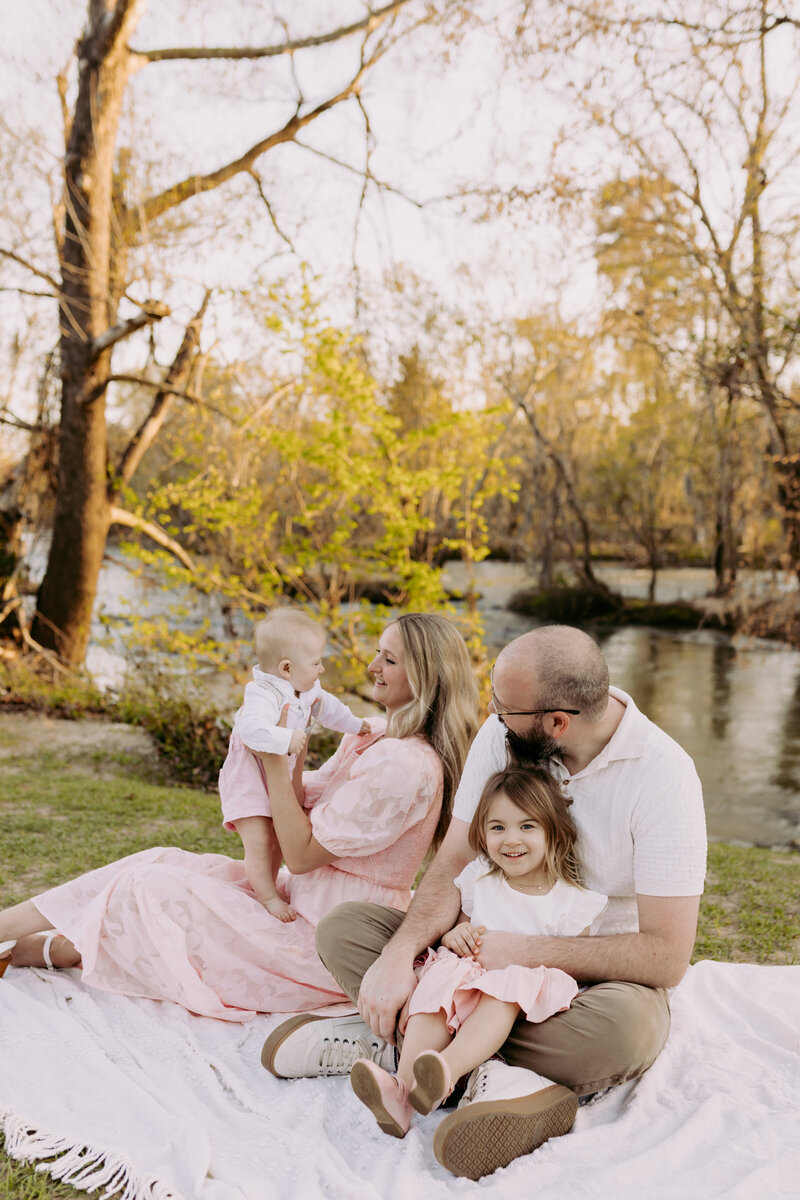 Bride and groom holding their hand while walking together at sunset on the evening of their wedding 