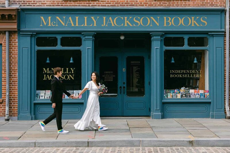 A couple walk past stores in South Street Seaport.