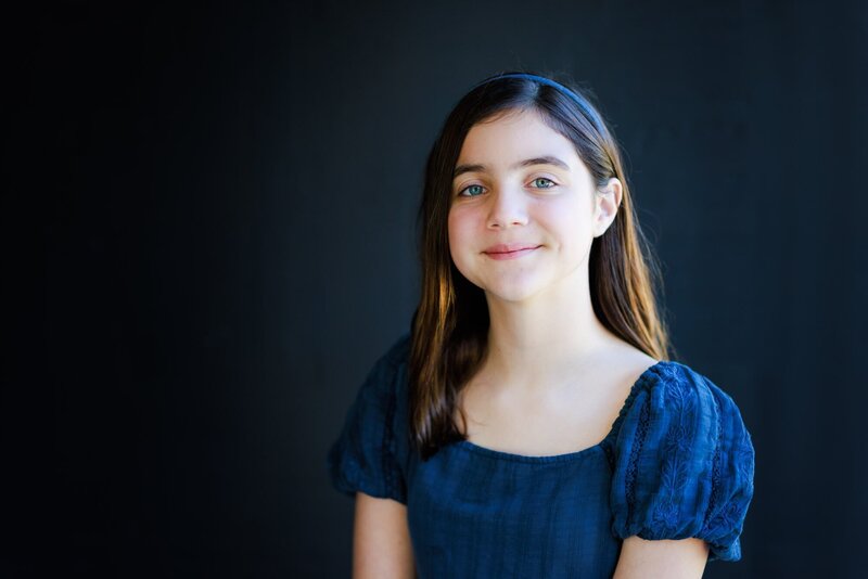 Sweet actor headshot of a girl  in a blue dress.