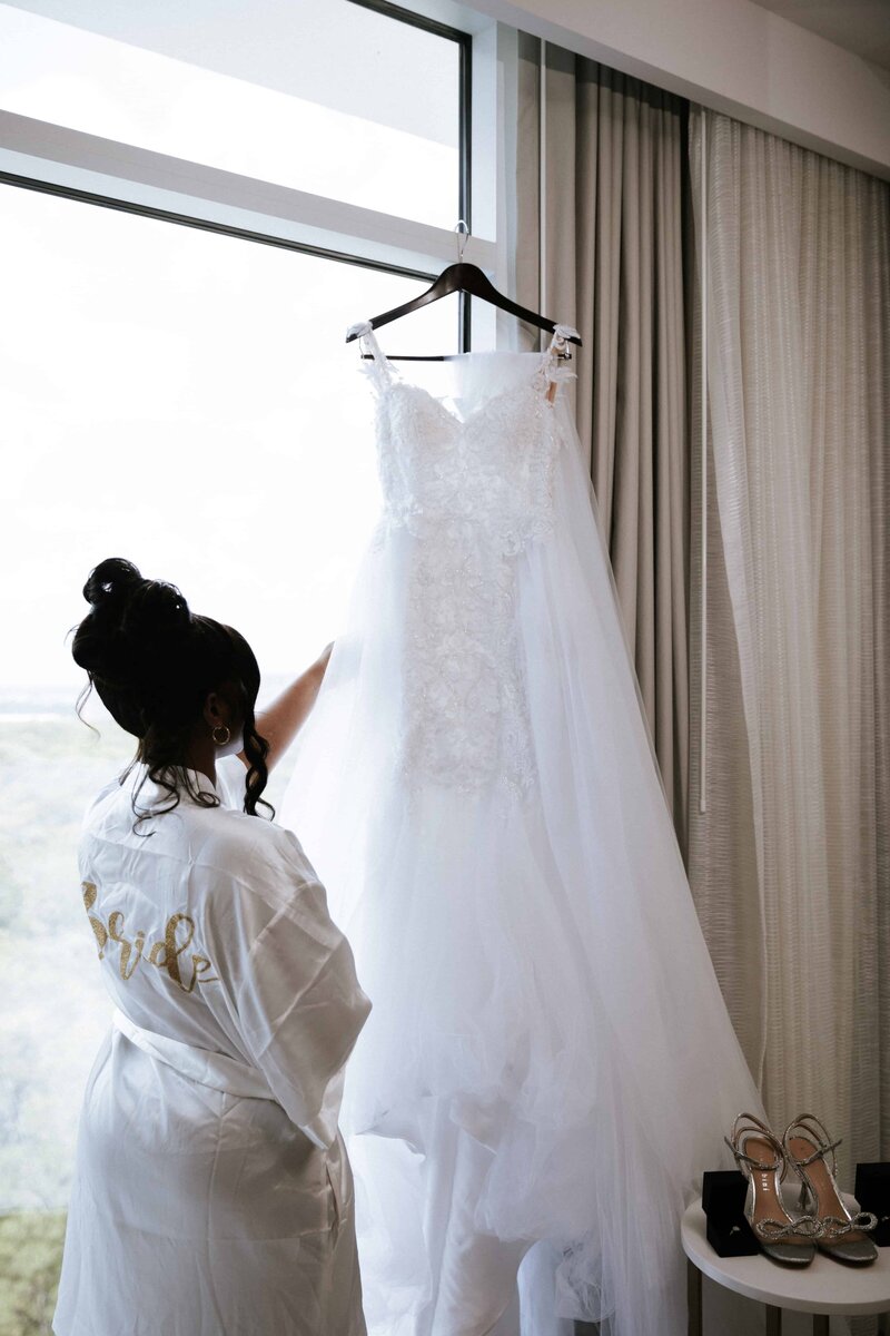 Bride in robe with wedding dress | JW Marriott Bonnet Creek Wedding Photos by Phavy Photography | Wedding Photographer in St. Augustine