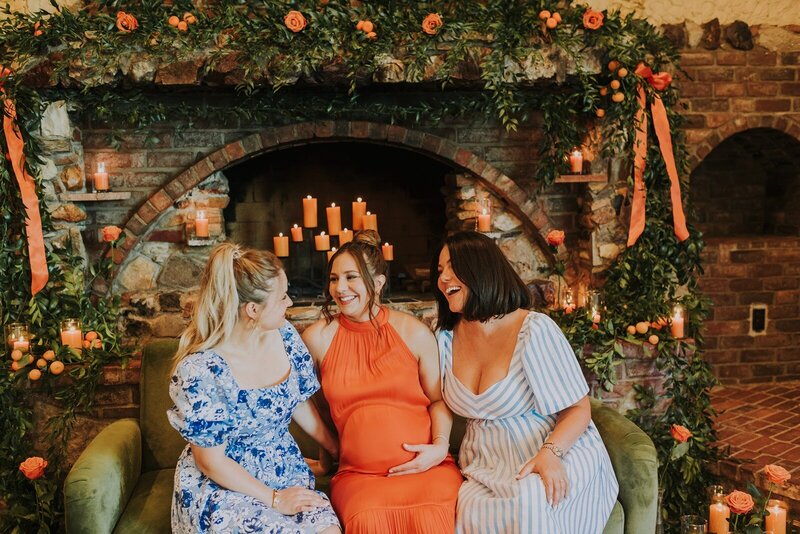 girls laughing and smiling at each other in a bridal shower in century room at grbic events in st. louis