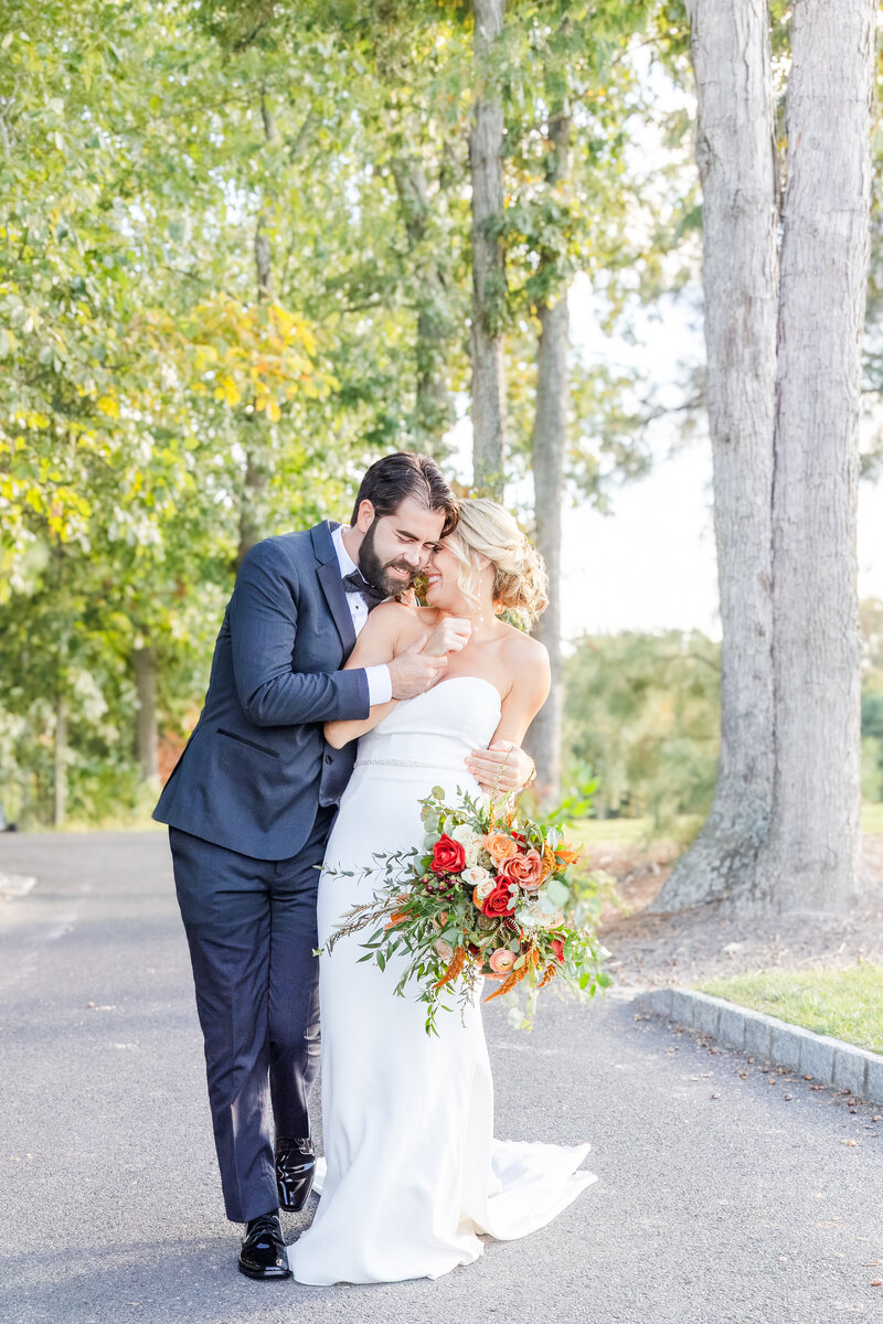 Couple walking down the sidewalk in mid michigan after just getting married.