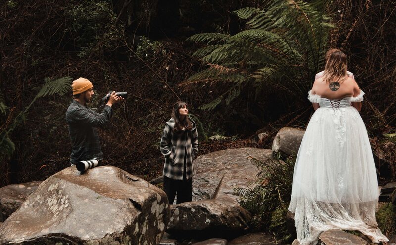 Photographer Peter Ali shooting an elopement in front of a waterfall