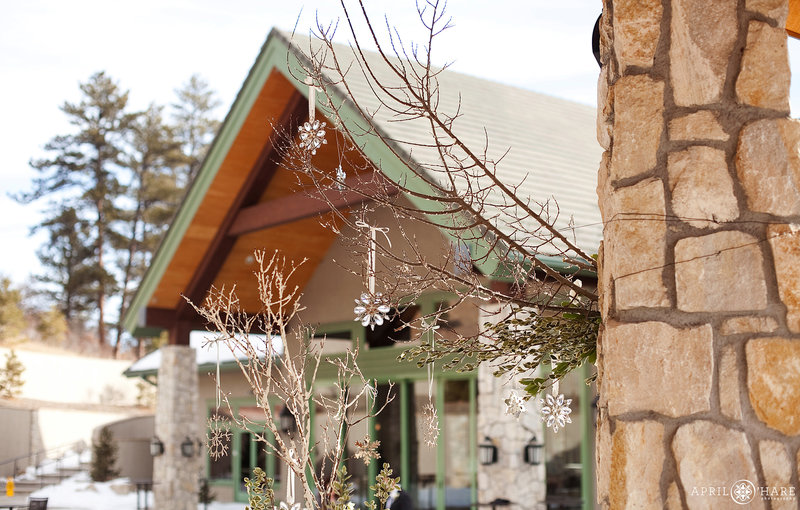 View of Cielo at Castle Pines from the outdoor covered patio ceremony space with winter snowflake decor hanging