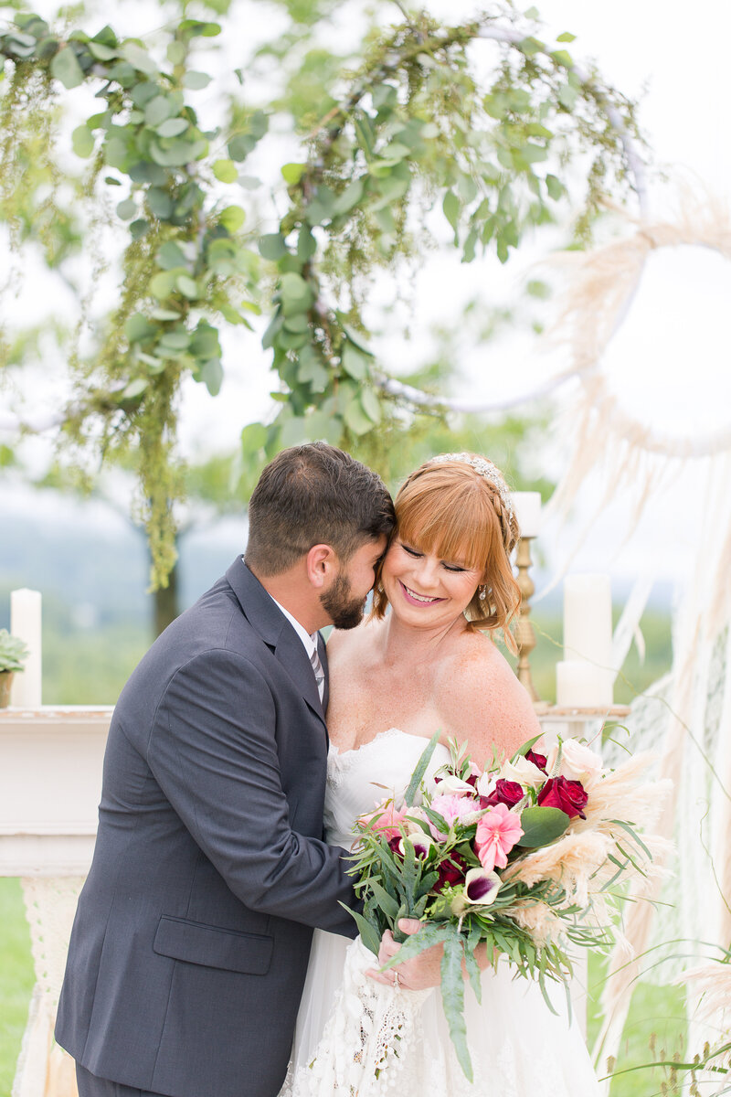 husband and wife on wedding day with bouquet