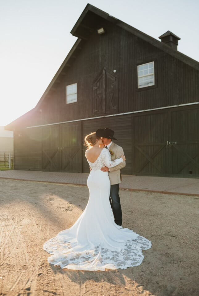 Bride and groom by barn at Nebraska wedding venue