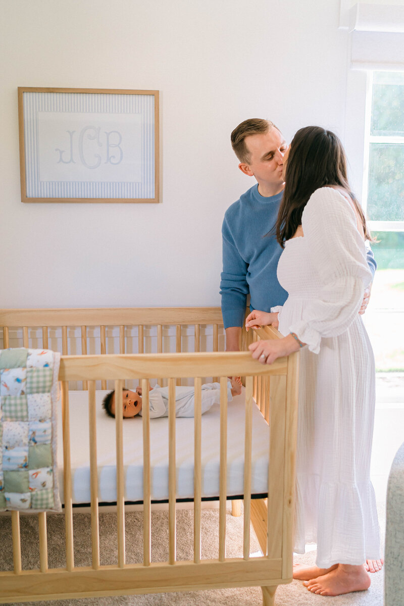 at home newborn photos , Tender moment between dad and his newborn son on the couch, bathed in dreamy natural light during an in-home session by Sugar House Utah newborn photographer