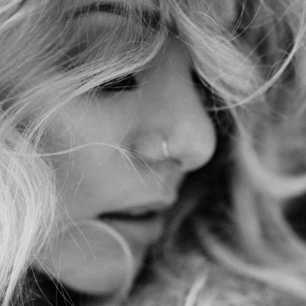 black and white girl with nose ring looking down senior portrait