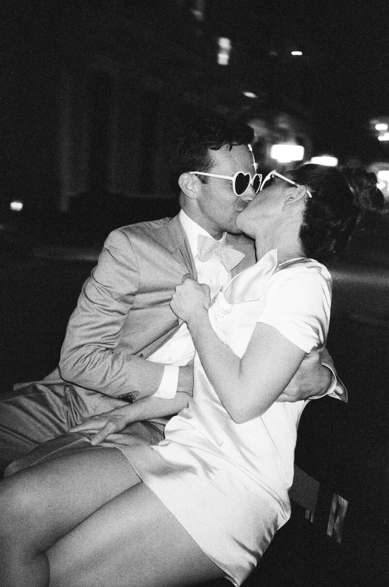 A couple kissing on the streets of New Orleans at their wedding reception