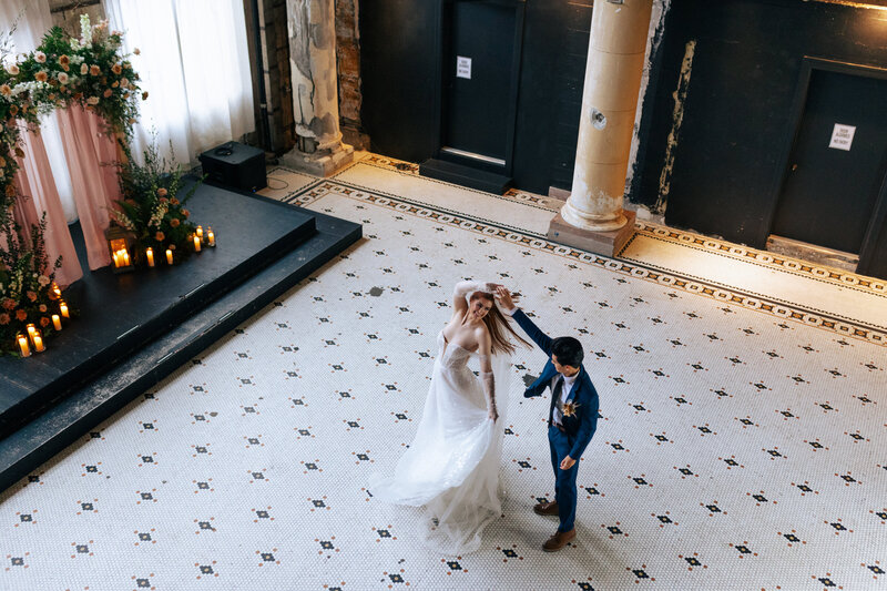couple dancing in a hall setting in front of where they got married Oregon Coast Elopement and Wedding Photographer