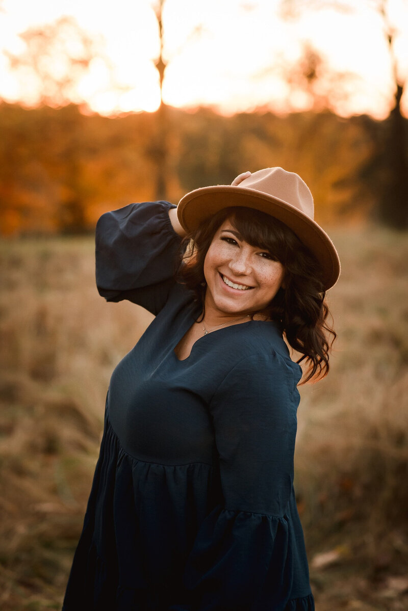 Brunette Woman holding hat smiling Maryland photographer