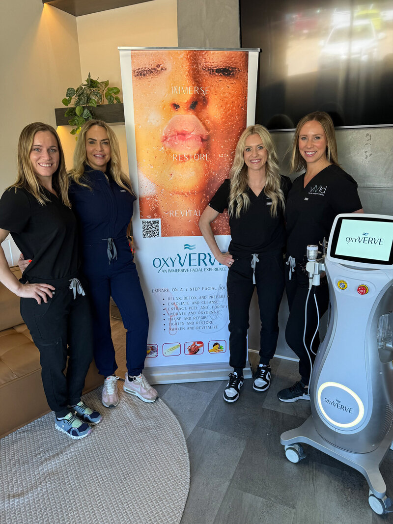 Four nurse practitioners standing in front of the OxyVERVE machine