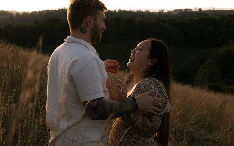 Unfiltered couples photography session in a field showing the beauty in genuine emotion