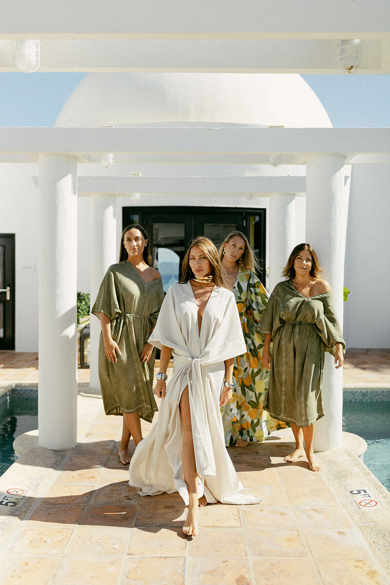 Bride and bridesmaids getting ready in stylish robes at Cap Juluca in Anguilla for a destination wedding