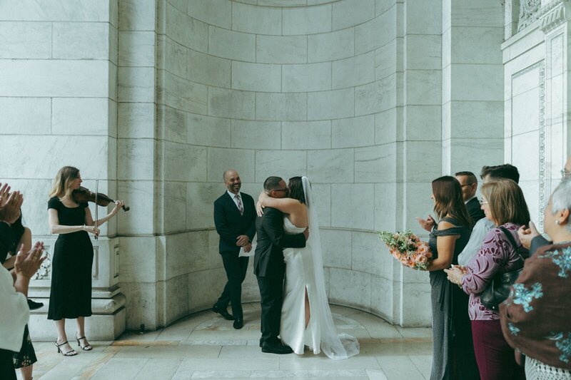 bride and groom's first kiss at NYPL elopement shot by Elsie Goodman Photography | NYC Elopement Packages