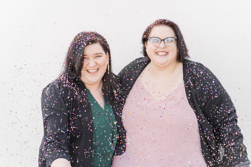 two sacramento wedding photographers throwing confetti.