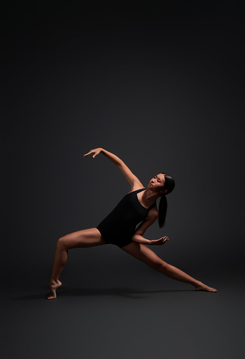 Photography Business Coach | Karinda K | Karinda sitting at a purple studio