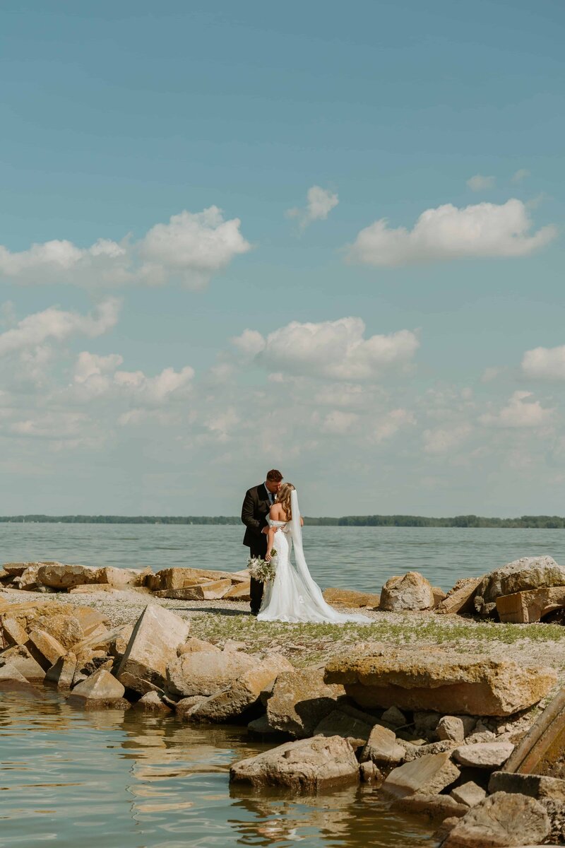 man and woman standing by a lake