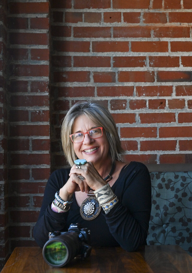 Jill P. Mott, photographer, sits in a Colorado coffee shop. 