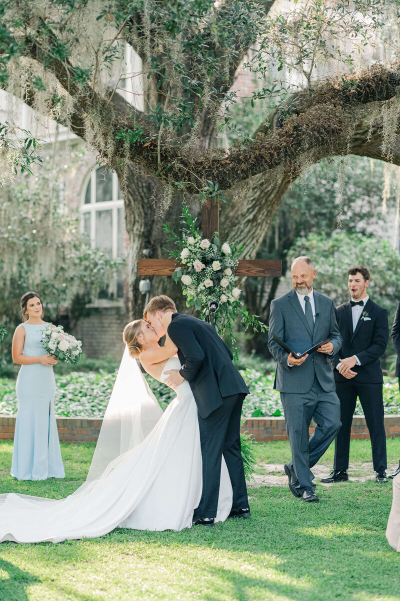 Bride and groom during first kiss at their wedding ceremony