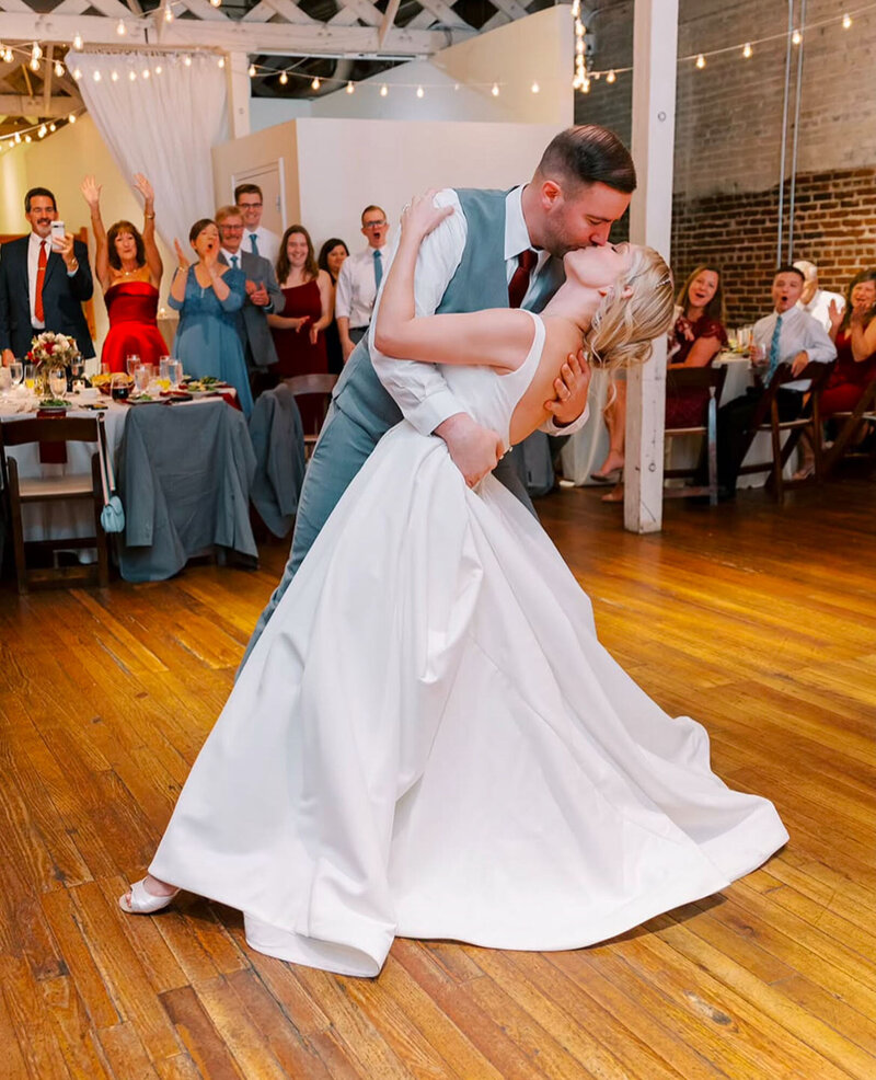 Bride and groom kissing on dance floor at Raleigh wedding