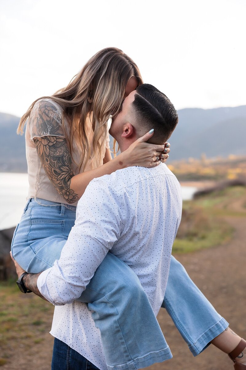 Engaged couple hugging at a car wash in Medford