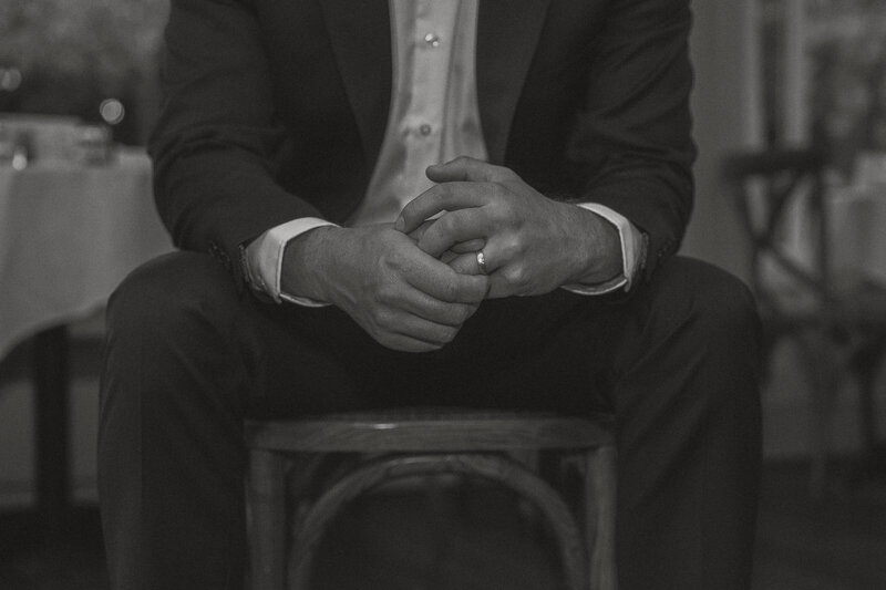 Groom holding ring during wedding portraits at Cuckoo Trattoria in Coombs by latitude 49 photography