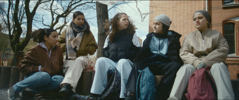 A tight portrait of a main character on the verge of tears, lit by a single soft source.