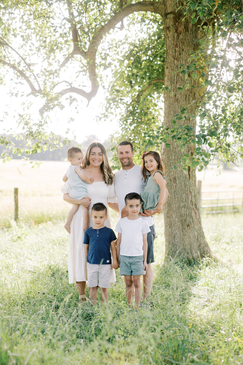 Portrait of a family standing in a farm field together