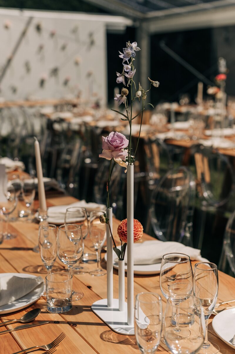 clear marquee christchurch loula hire with white and wood decor with pastel pink and orange florals