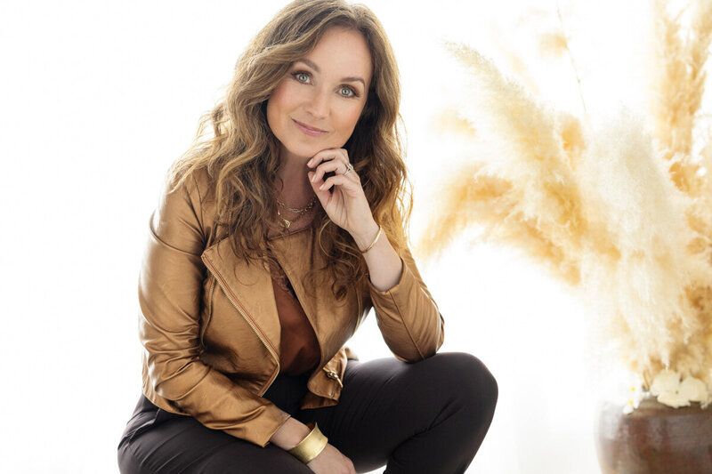 gabriella taylor life coach in maroon shirt leaning against wall