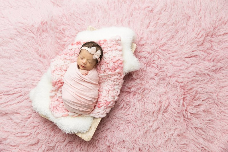 baby girl pink wrap on pink flokati