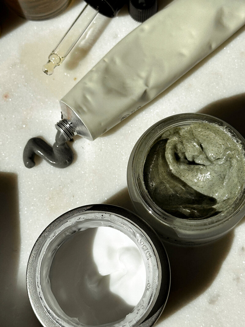 A flat lay of carefully selected non-toxic beauty products, showcasing Wildseed Health's commitment to clean, natural self-care.