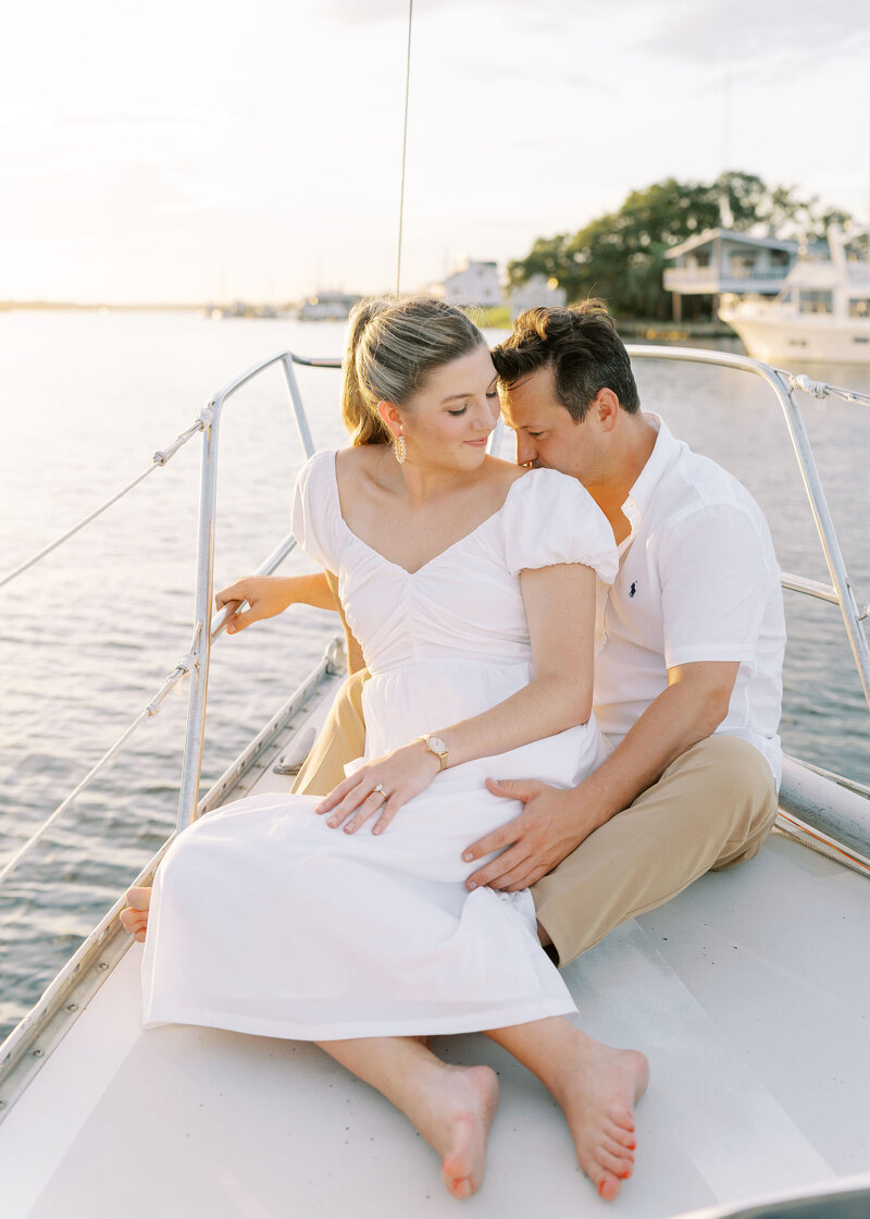 couple embracing while on a sailboat
