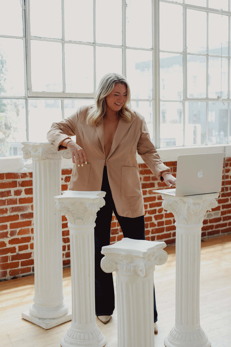 Visually appealing website design inspiration featuring a modern and elegant businesswoman working on her laptop. This aesthetic edit embodies a high-design website feel, perfect for showcasing professional website design services and impactful website design for female entrepreneurs