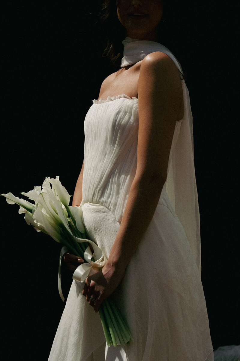 beautiful bride in queenstown with black and white photo in modern wedding dress with hair and makeup professionally done in queenstown