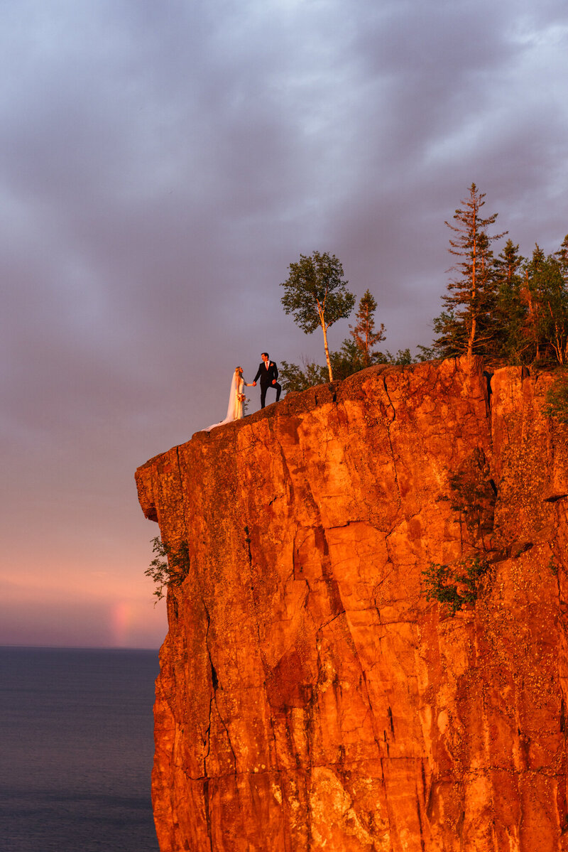 couple walking on Palisade Head cliff taken by Minnesota elopement photographer Marcus Hanenburg Photography
