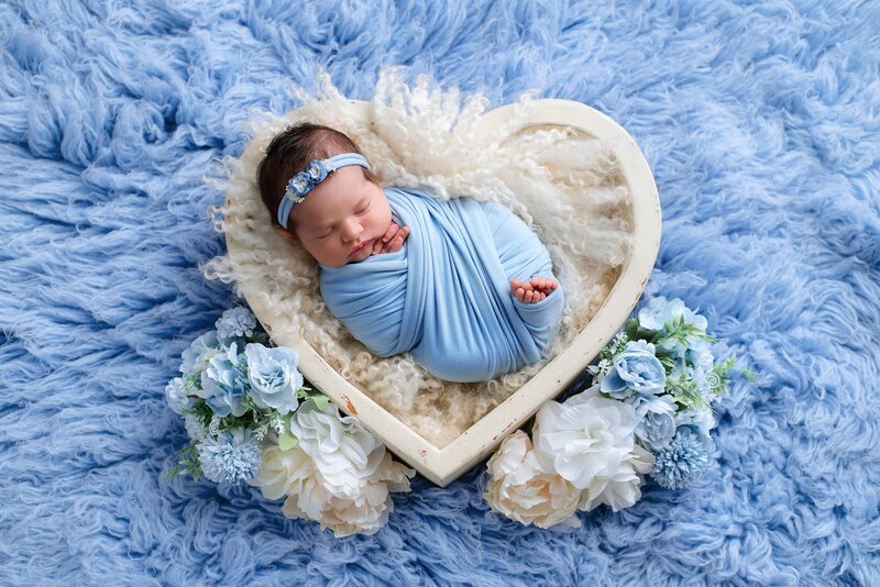Vancouver studio newborn session with newborn girl in a blue heart bowl with flowers