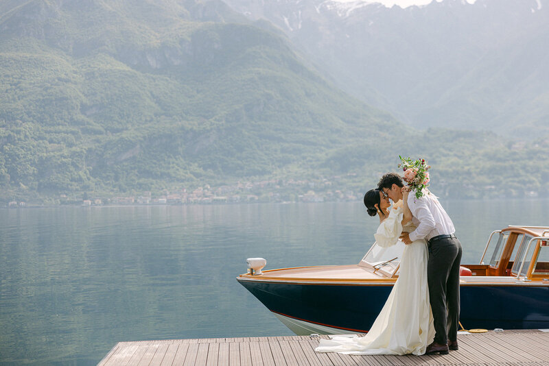 bride and groom kissing with Lake Como in the background