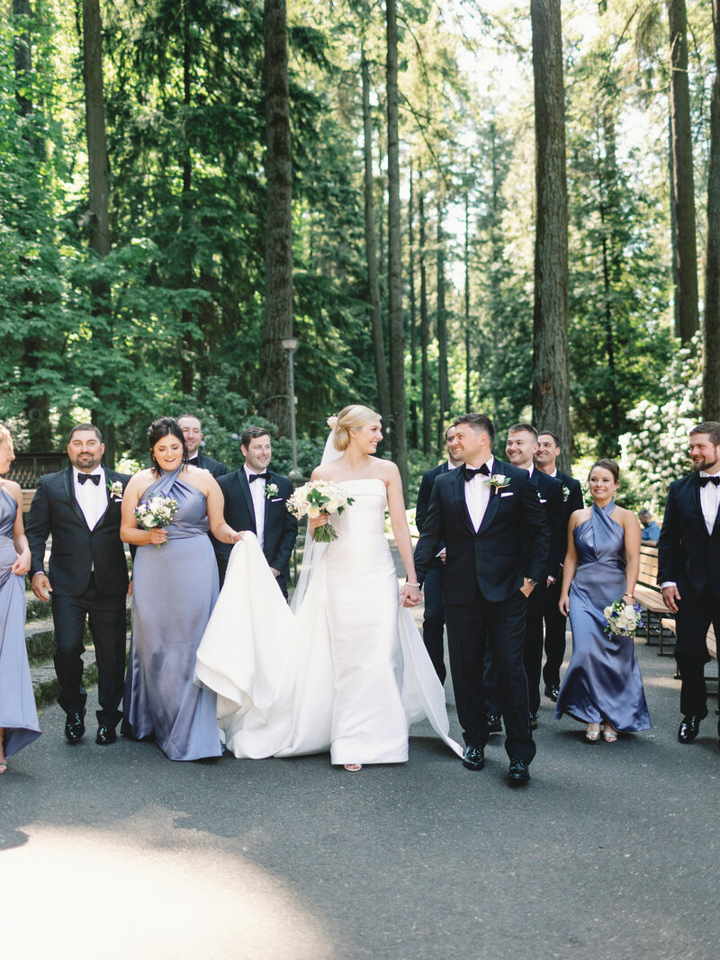 modern bride, groom, and attendants in a forest setting