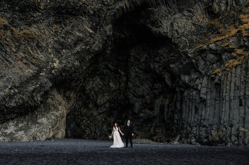 Epic eloping couple on a black sand beach in Iceland.