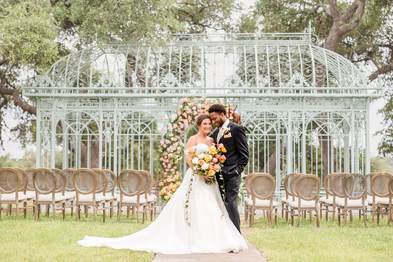 Bride and groom embrace during their wedding at Ma Maison, one of Austin’s best wedding venues.