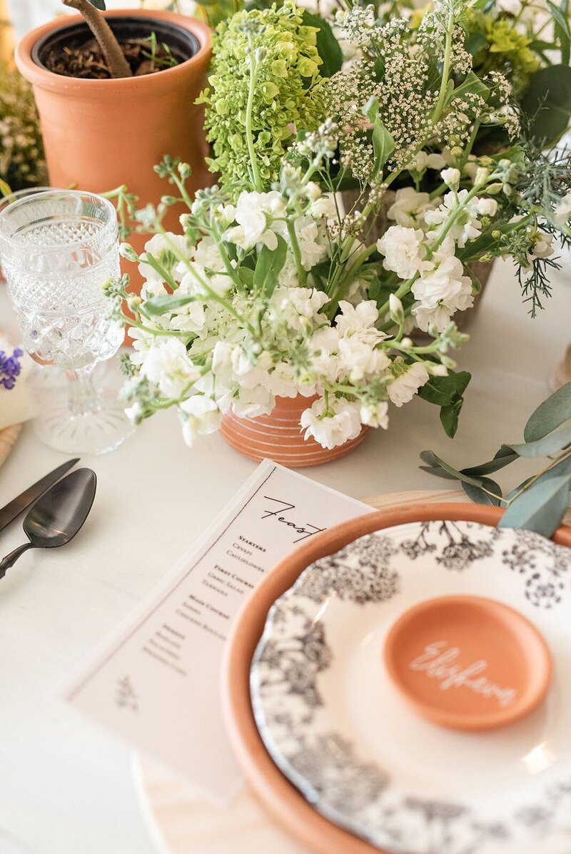 terracotta and floral-themed table setting at grbic events, a wedding venue in st. louis