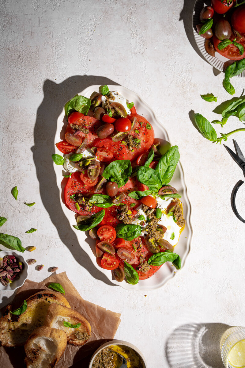 a colorful dish of stuffed eggplants, garnished with parsley and pomegranate seeds